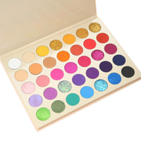 Makeup palette with a variety of colorful eyeshadows on a white background